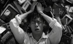 Person Overwhelmed By Technology Devices