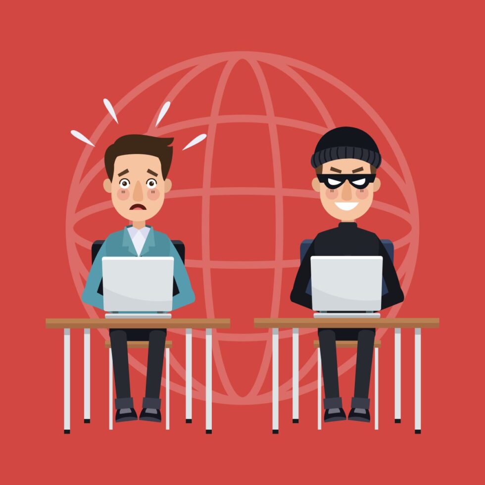 Two Men Sitting At Desks With Laptops